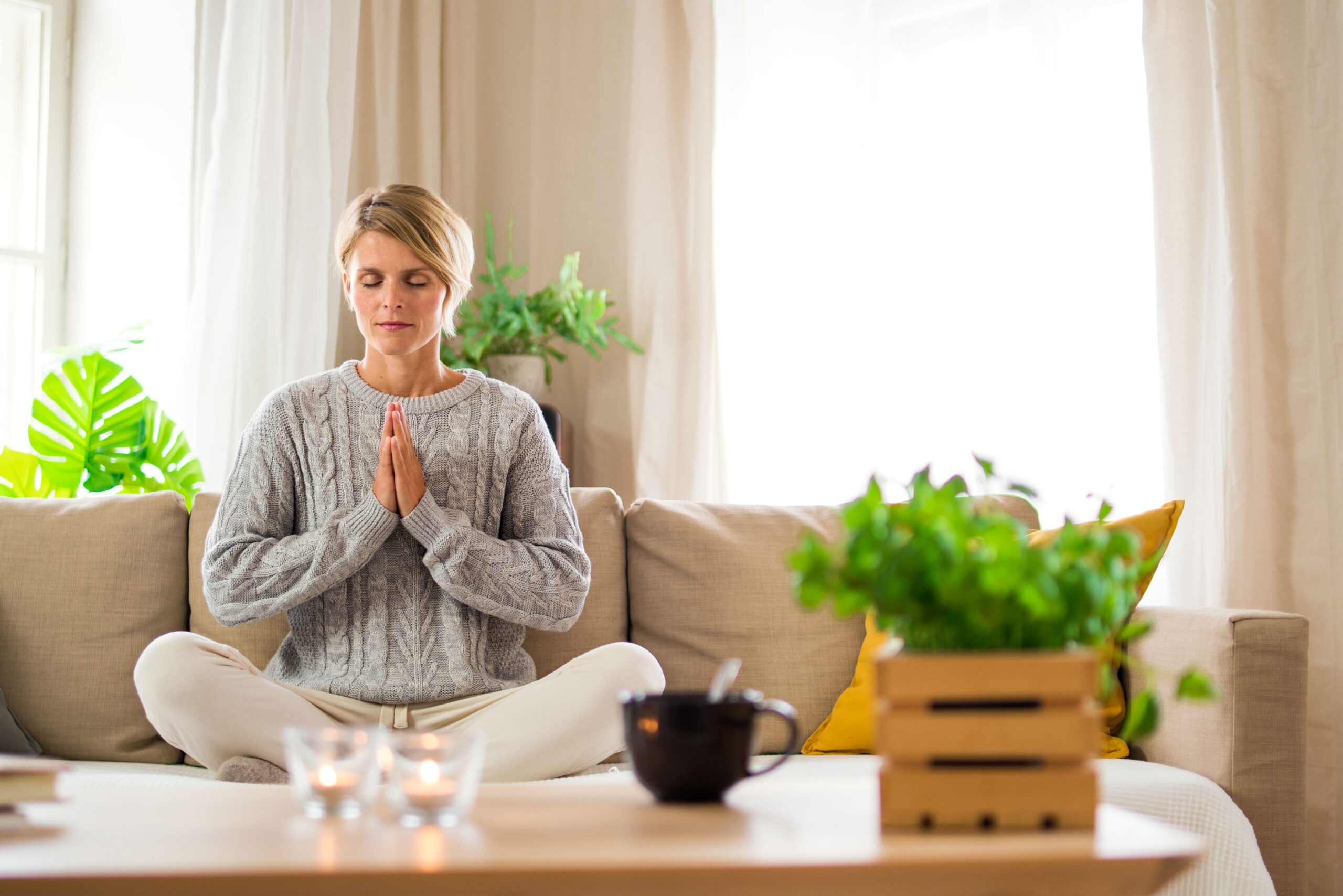  An adult sitting quietly near a window, reflecting the long recovery phase and ongoing gut sensitivity after illness