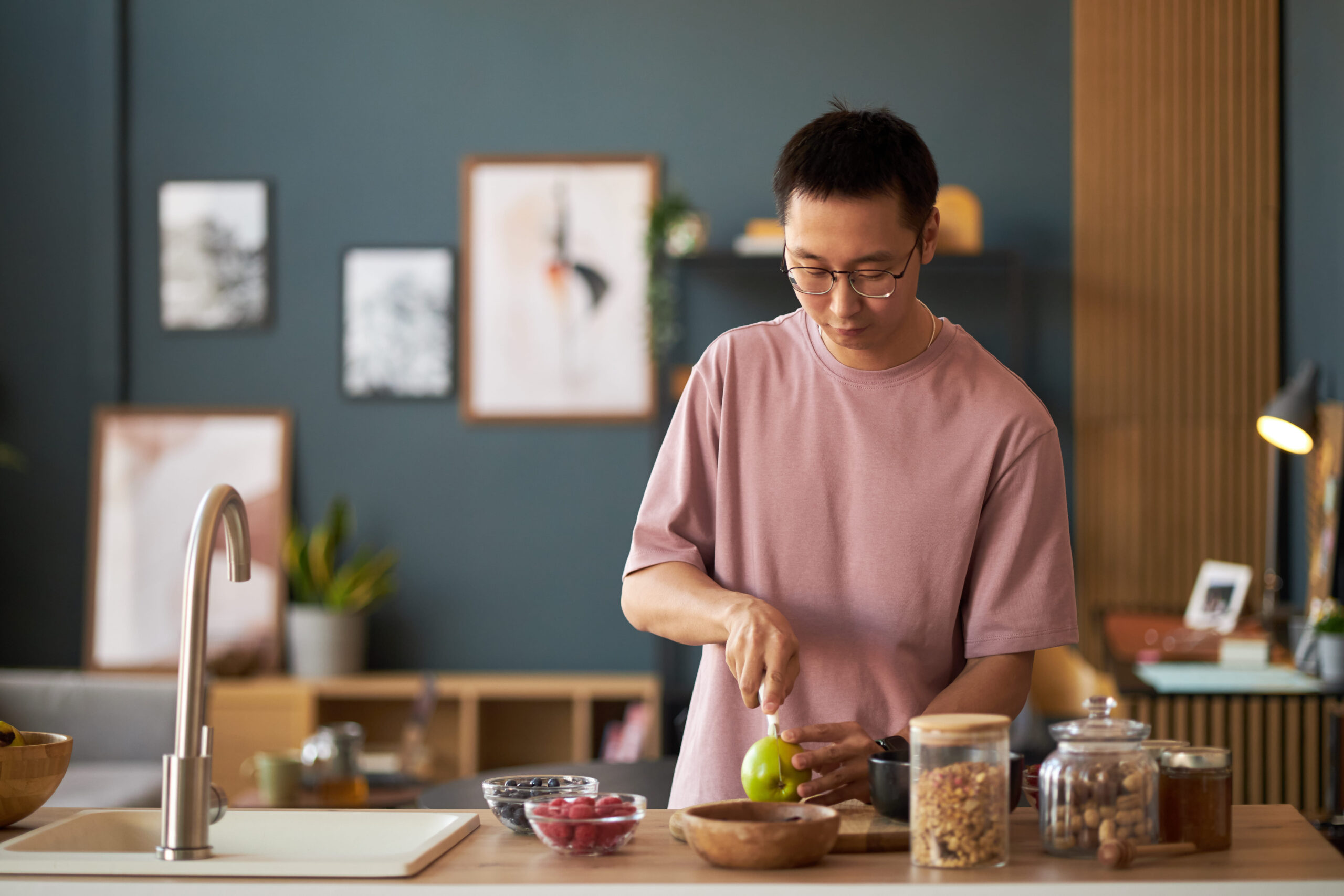 An adult preparing a simple meal calmly, representing gradual digestive recovery and cautious reintroduction of normal eating after illness